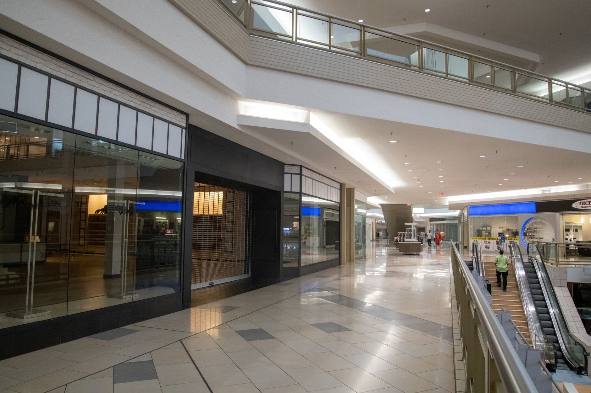 A shopping mall corridor lined with storefronts